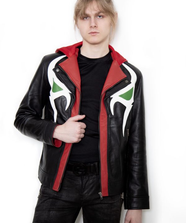 (Front): Photo of a model wearing a black leather jacket. The jacket is a motorcycle cut with a red hood and a red leather lining that is visible inside the cuffs and the folded down collar. There is also a strip of red leather either side of the front zipper. Where breast pockets typically would be on a jacket, there are [handpainted/patched] green eyes surrounded by white details. The collar has metal pop buttons to hold it in place. (Back): Photo of the same black leather jacket with a red hood. The jacket is a motorcycle cut. The inside of the hood has a mesh lining.